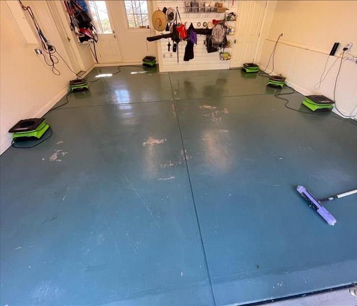 Air movement machines drying out garage floor. 