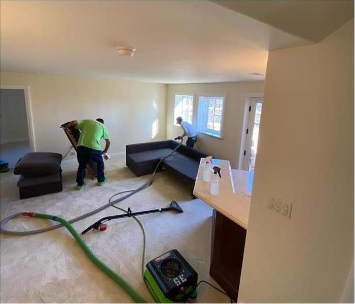 Specialist are cleaning water damage in a home.